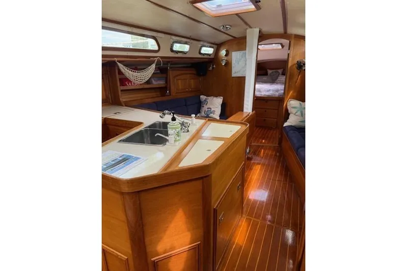 Star Yacht Photos Pics Interior of 1998 Sabre 402 sailboat with wooden finish and cozy seating area.