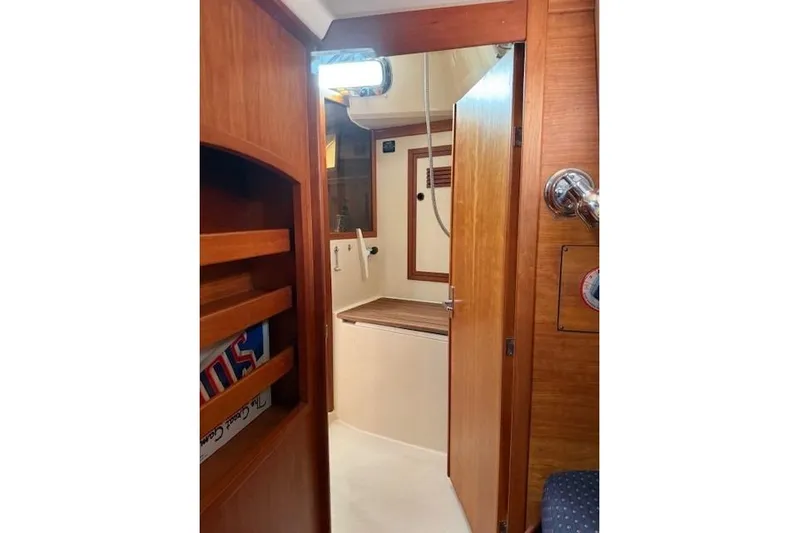 Star Yacht Photos Pics Interior of 1998 Sabre 402 sailboat, featuring wooden cabinetry and compact bathroom.