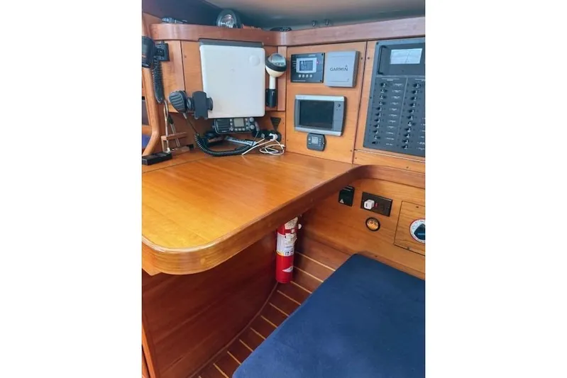 Star Yacht Photos Pics Navigation station in a 1998 Sabre 402 sailboat with control panels and equipment.