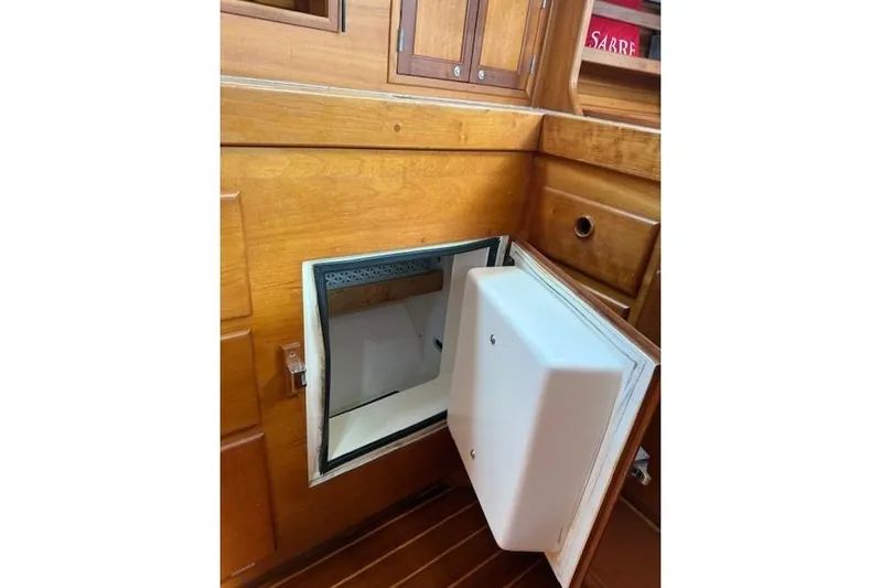 Star Yacht Photos Pics Open storage compartment in 1998 Sabre 402 yacht with wooden interior.