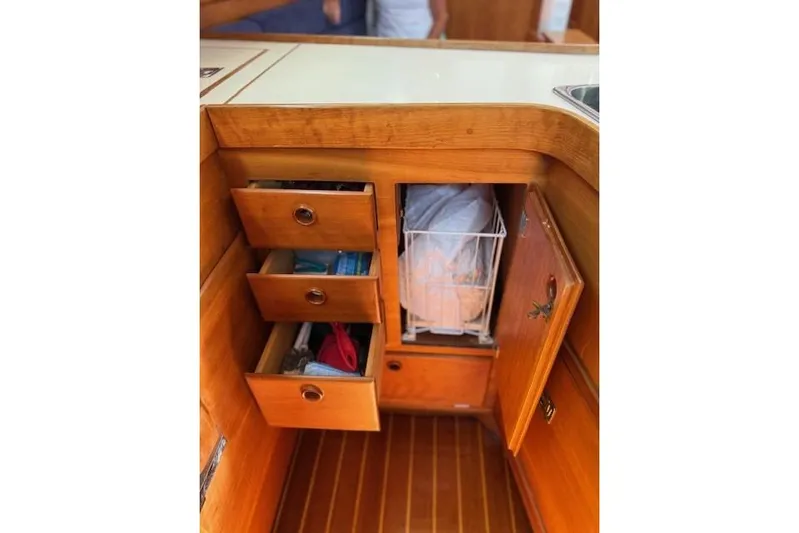 Star Yacht Photos Pics 1998 Sabre 402 yacht interior with wooden drawers and storage cabinet.