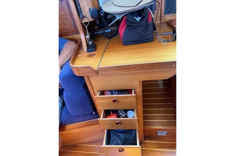 Star Yacht Photos Pics Wooden interior of a 1998 Sabre 402 sailboat with open drawers and equipment.