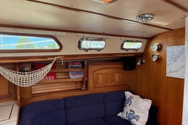 Star Yacht Photos Pics Interior of 1998 Sabre 402 sailboat with blue seating and wooden cabinetry.