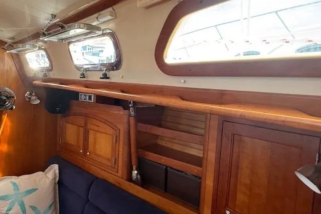 Star Yacht Photos Pics Interior of 1998 Sabre 402 sailboat with wooden cabinetry and blue seating.