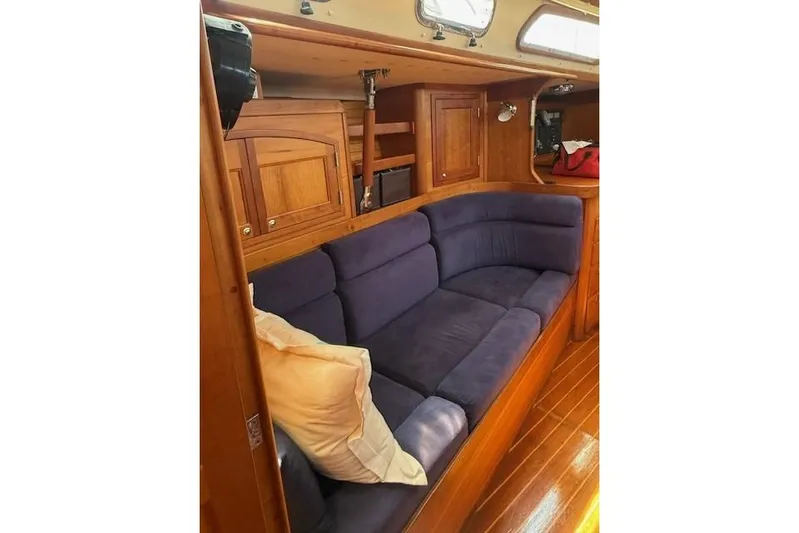 Star Yacht Photos Pics Interior of 1998 Sabre 402 yacht with blue cushioned seating and wooden cabinetry.