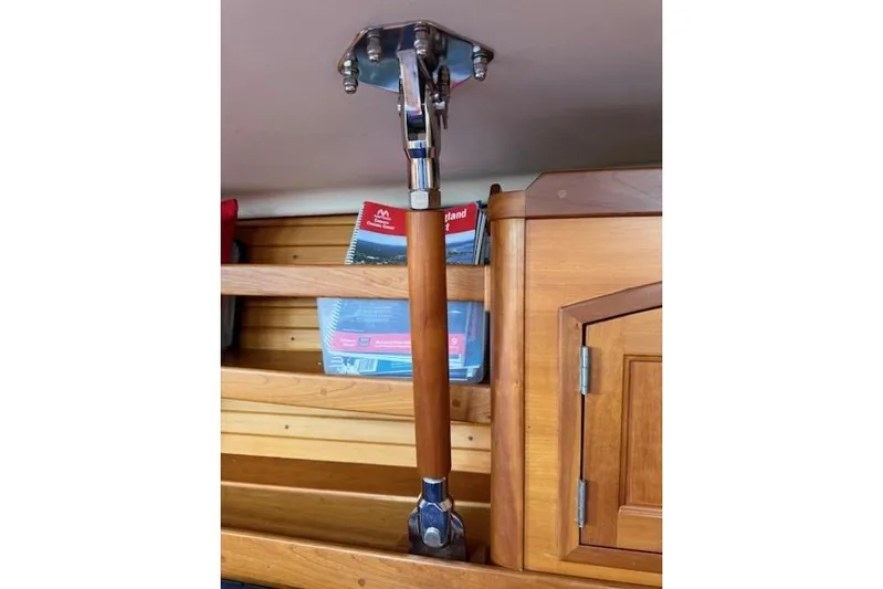 Star Yacht Photos Pics Wooden support beam inside 1998 Sabre 402 yacht cabin, with books and wooden cabinetry.