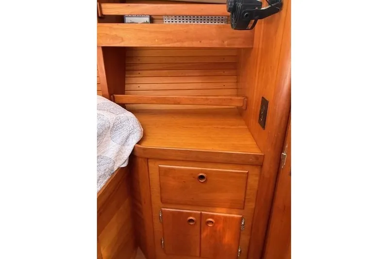 Star Yacht Photos Pics 1998 Sabre 402 yacht interior with wooden cabinetry and storage space.