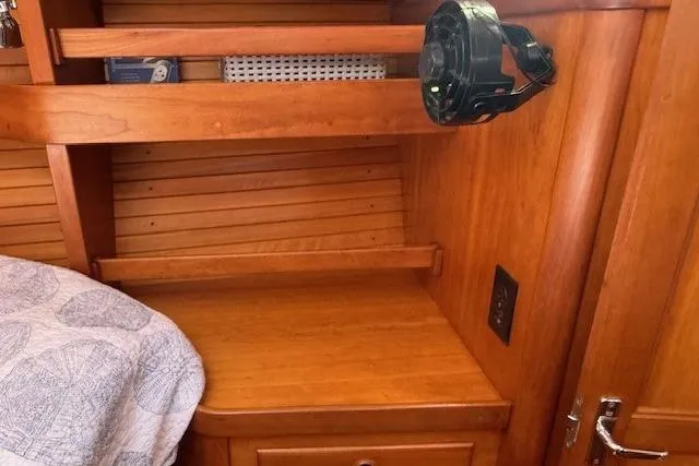 Star Yacht Photos Pics 1998 Sabre 402 interior with wooden shelves and a mounted fan.