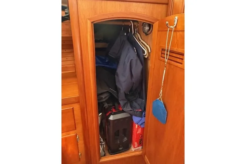 Star Yacht Photos Pics Wooden closet interior on a 1998 Sabre 402 yacht, with clothes and equipment.