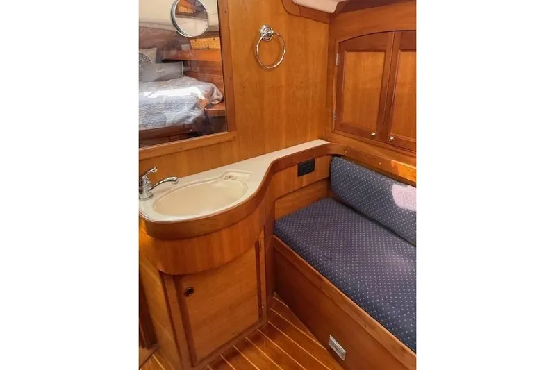Star Yacht Photos Pics Interior of 1998 Sabre 402 yacht with wooden cabinetry and seating area.
