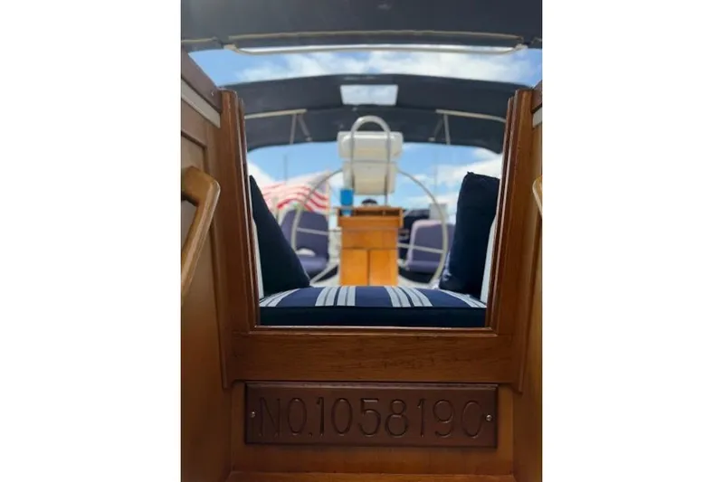 Star Yacht Photos Pics Interior view of 1998 Sabre 402 sailboat with striped cushions and wooden details.