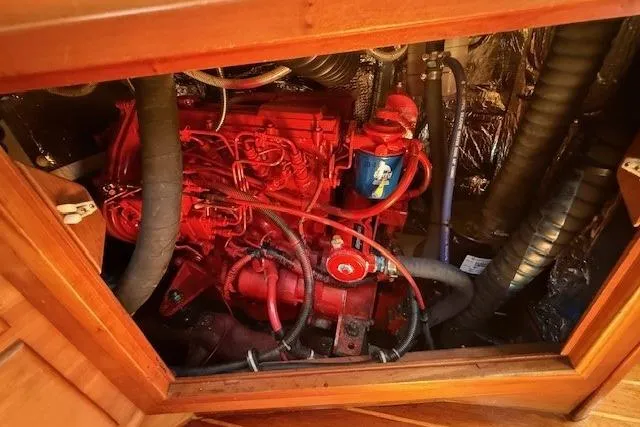 Star Yacht Photos Pics Engine compartment of a 1998 Sabre 402, featuring a red engine and various hoses.