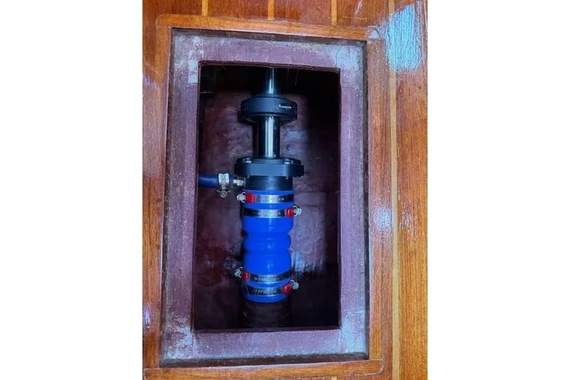 Star Yacht Photos Pics 1998 Sabre 402 boat component with blue hose and clamps in wooden compartment.