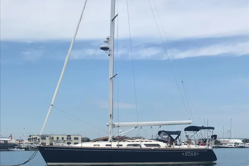 Star Yacht Photos Pics Sailboat Sabre 402, 1998 model, docked in a marina under a clear sky.