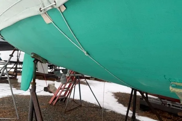 Star Yacht Photos Pics Green hull of a 1998 Sabre 402 sailboat on a snowy boatyard.