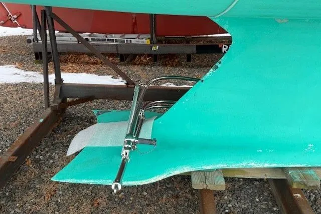 Star Yacht Photos Pics 1998 Sabre 402 sailboat keel and rudder on gravel, showcasing marine hardware.