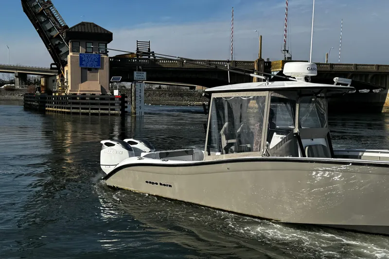  Yacht Photos Pics 2024 Cape Horn 32 T boat navigating near a raised drawbridge on a sunny day.