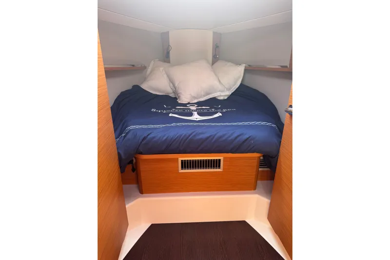 Squeeze De Citron Yacht Photos Pics Cozy cabin interior of 2023 Dufour 37 yacht with nautical bedding.