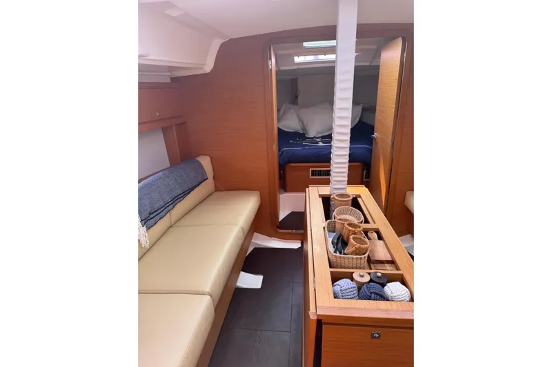Squeeze De Citron Yacht Photos Pics Interior of 2023 Dufour 37 yacht with cozy seating and storage baskets.