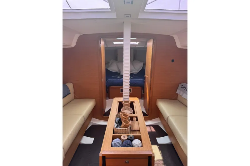 Squeeze De Citron Yacht Photos Pics Interior of 2023 Dufour 37 yacht, featuring cozy seating and elegant wooden finishes.