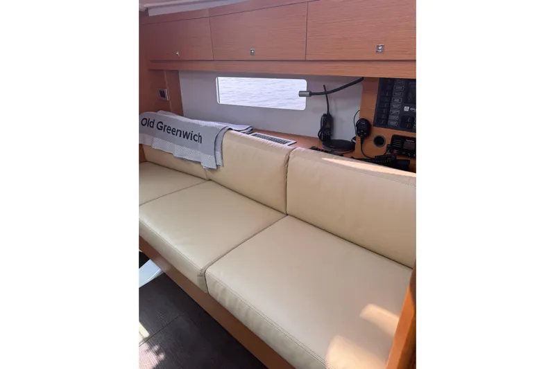 Squeeze De Citron Yacht Photos Pics Interior of 2023 Dufour 37 yacht with beige seating and navigation equipment.