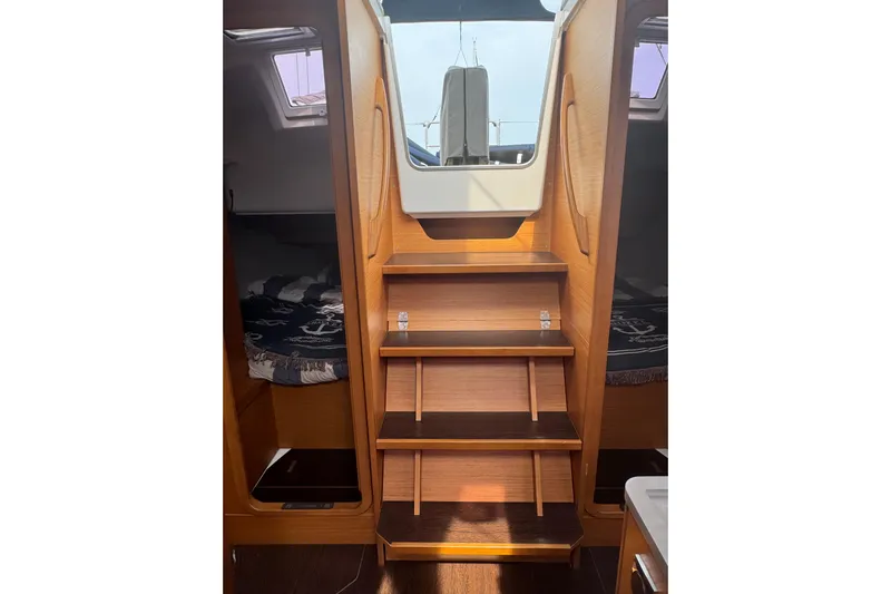 Squeeze De Citron Yacht Photos Pics Interior of 2023 Dufour 37 yacht, featuring wooden steps and cozy cabin spaces.