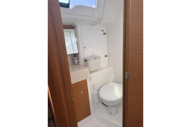 Squeeze De Citron Yacht Photos Pics 2023 Dufour 37 yacht bathroom with modern fixtures and wooden accents.