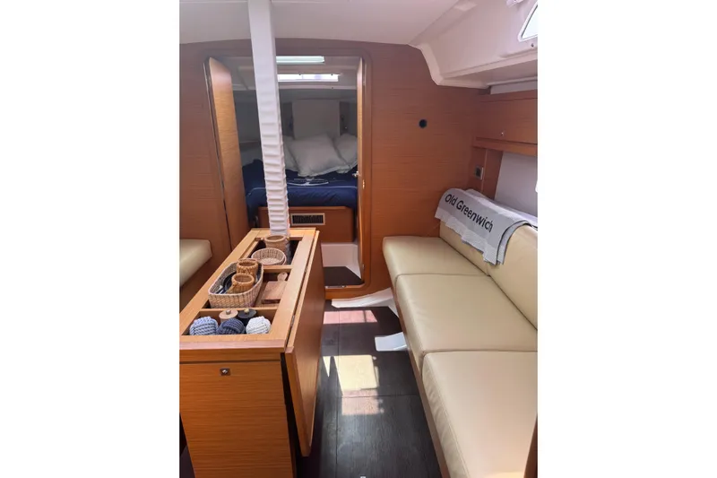 Squeeze De Citron Yacht Photos Pics 2023 Dufour 37 yacht interior with cozy seating and elegant wood finish.