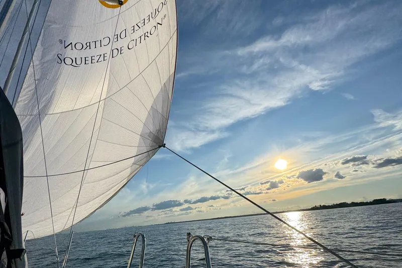 Squeeze De Citron Yacht Photos Pics Sailing on a 2023 Dufour 37 yacht at sunset with billowing sails.