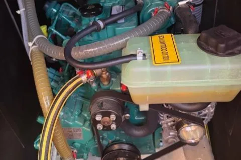 Squeeze De Citron Yacht Photos Pics Engine compartment of 2023 Dufour 37 sailboat, featuring coolant system and hoses.