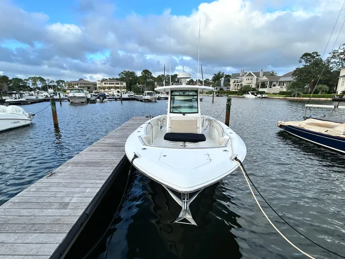  Yacht Photos Pics 2017 Boston Whaler 330 Outrage docked in a scenic marina.