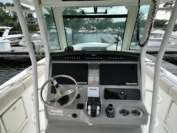  Yacht Photos Pics 2017 Boston Whaler 330 Outrage helm with Raymarine electronics at marina dock.