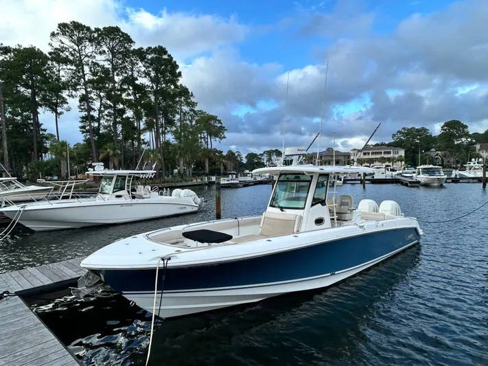  Yacht Photos Pics 2017 Boston Whaler 330 Outrage docked in a scenic marina setting.
