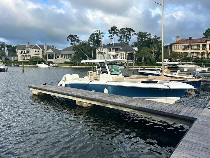  Yacht Photos Pics 2017 Boston Whaler 330 Outrage docked in a scenic marina setting.