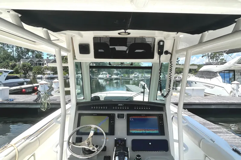  Yacht Photos Pics 2017 Boston Whaler 330 Outrage helm with advanced navigation system at marina.