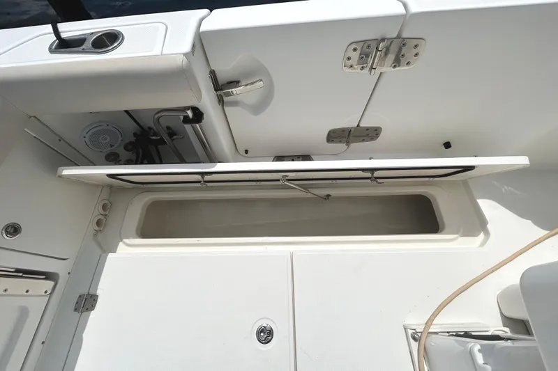  Yacht Photos Pics 2017 Boston Whaler 330 Outrage storage compartment with open hatch and stainless steel hardware.
