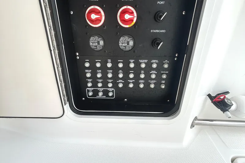  Yacht Photos Pics Control panel of a 2017 Boston Whaler 330 Outrage boat, featuring switches and dials.