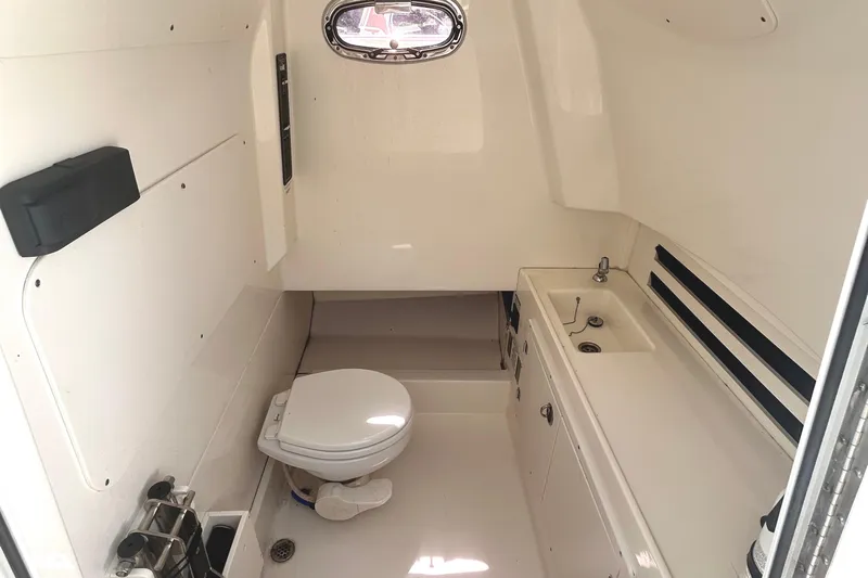  Yacht Photos Pics 2017 Boston Whaler 330 Outrage cabin interior with toilet and sink.