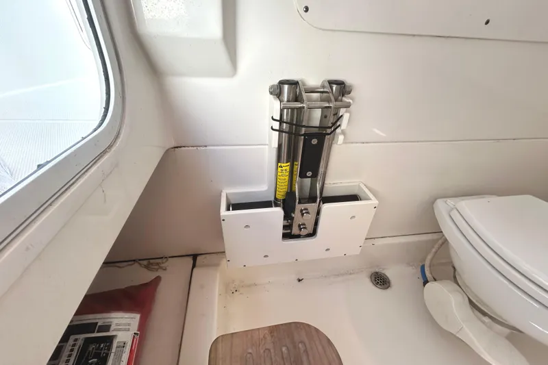  Yacht Photos Pics Interior of 2017 Boston Whaler 330 Outrage boat, featuring a compact bathroom setup.