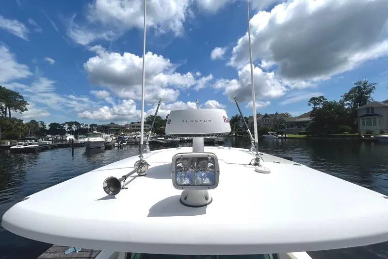  Yacht Photos Pics Boston Whaler 330 Outrage 2017 on calm water under a partly cloudy sky.