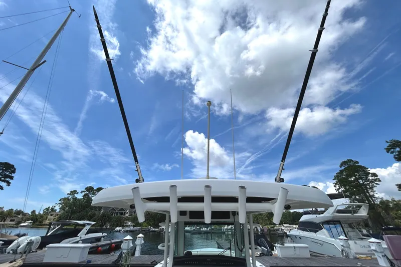  Yacht Photos Pics Boston Whaler 330 Outrage 2017 boat docked under a bright blue sky.