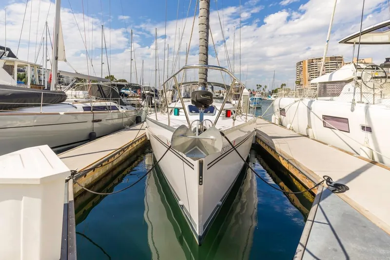Nina Mia Yacht Photos Pics 2018 Catalina 385 sailboat docked in a marina under a partly cloudy sky.