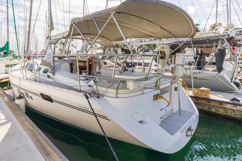 Nina Mia Yacht Photos Pics 2018 Catalina 385 sailboat docked at marina, featuring spacious deck and canopy.