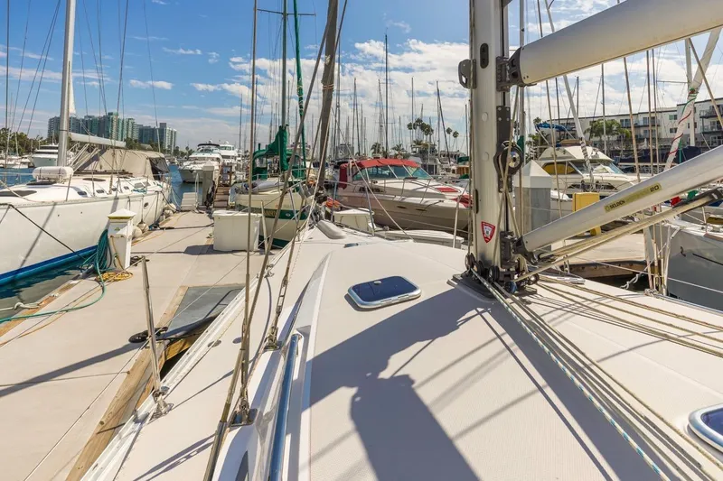 Nina Mia Yacht Photos Pics 2018 Catalina 385 sailboat docked in a sunny marina with other boats.