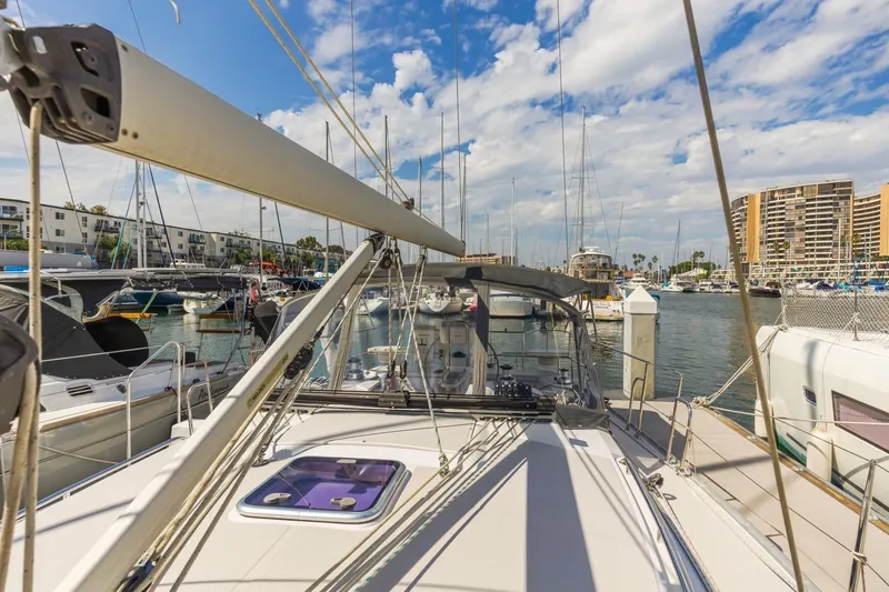 Nina Mia Yacht Photos Pics 2018 Catalina 385 sailboat docked in a marina, surrounded by other boats and buildings.
