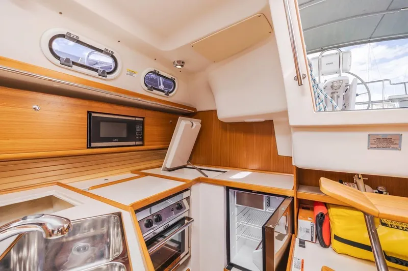 Nina Mia Yacht Photos Pics Modern galley kitchen in 2018 Catalina 385 sailboat with microwave and fridge.