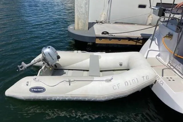 Nina Mia Yacht Photos Pics Inflatable dinghy with motor docked beside a 2018 Catalina 385 sailboat.
