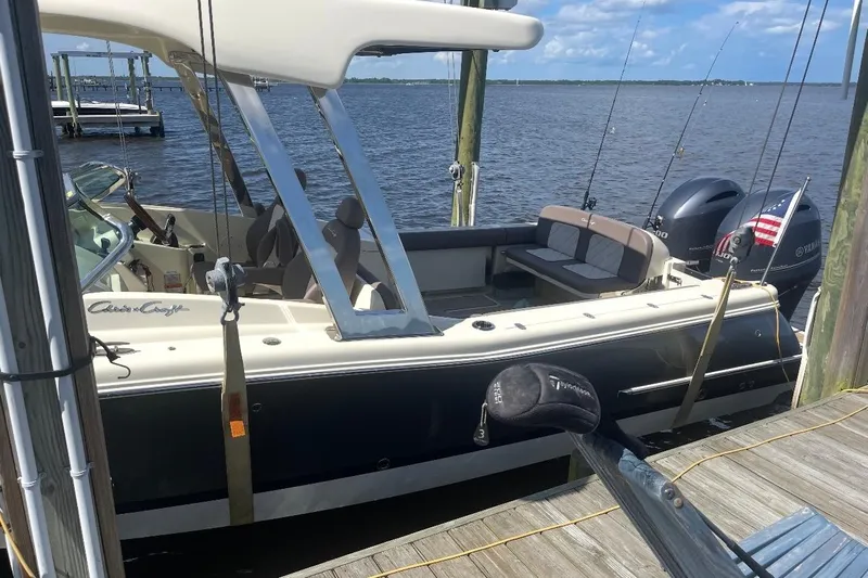  Yacht Photos Pics 2019 Chris-Craft Calypso 26 boat docked, featuring dual Yamaha engines and fishing rods.