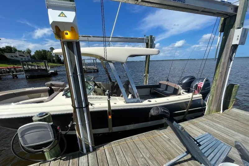  Yacht Photos Pics 2019 Chris-Craft Calypso 26 boat docked on a sunny day by the water.
