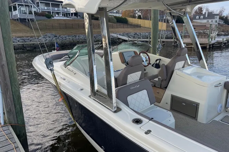  Yacht Photos Pics 2019 Chris-Craft Calypso 26 boat docked, featuring elegant seating and sleek design.